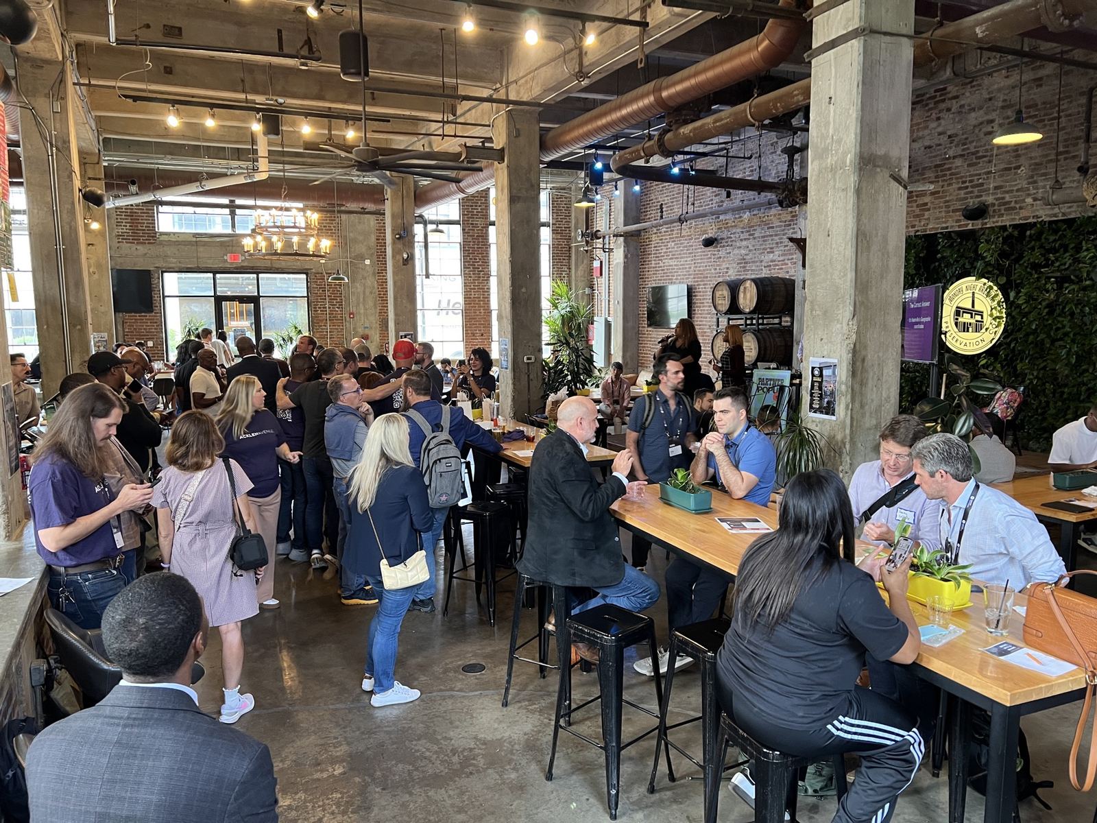 A full room of founders talking between sessions at Monday Night Brewing.